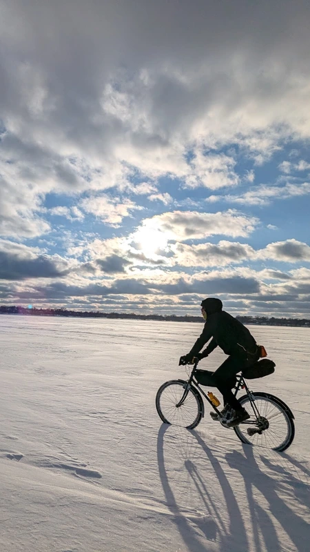 A racer riding across Lake Bde Maka Ska during Stupor Bowl.